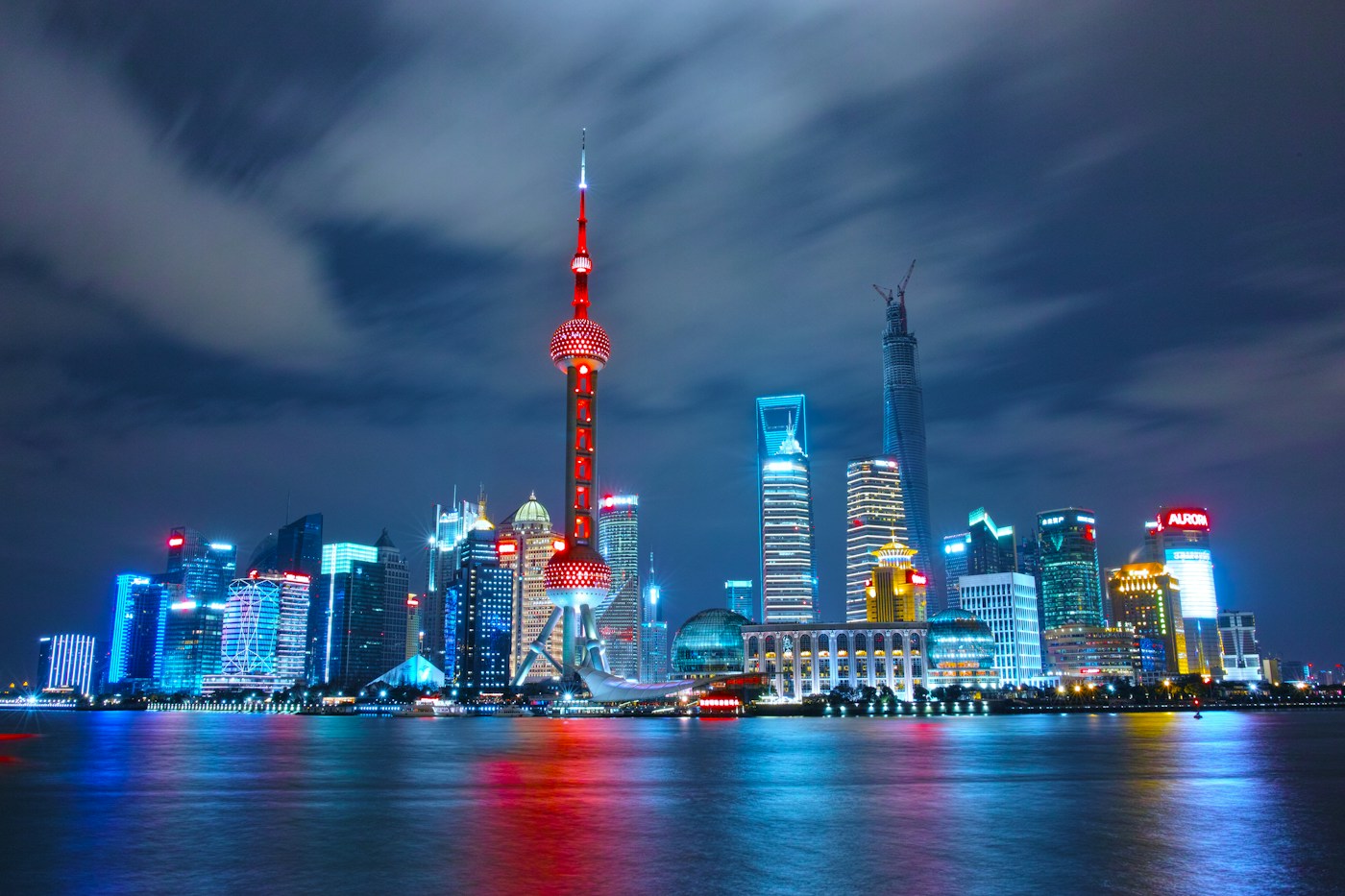 Shanghai skyline illuminated across the Huangpu River at dusk